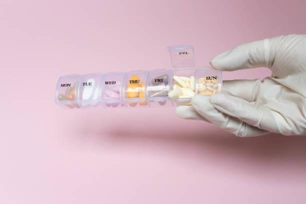 Daily Meds on pink background stock photo