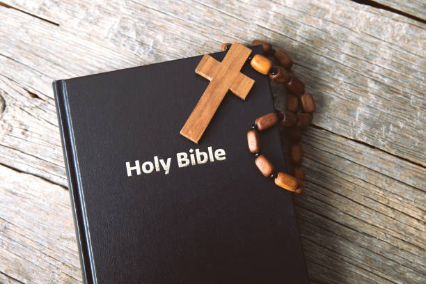 istock cross on Holy Bible 1300021126