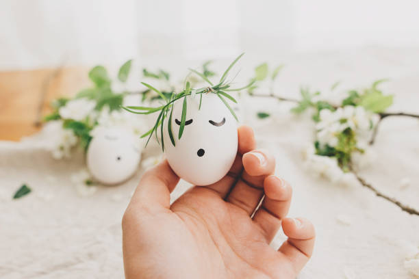 Young woman and a young man egg tapping on Easter. Young man's POV.