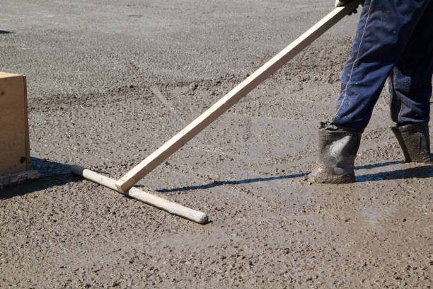 istock worker leveling fresh concrete slab with a special working tool 1300023269