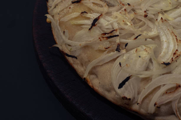 Home made onion italian Pizza with cheese and vegetables on black background
