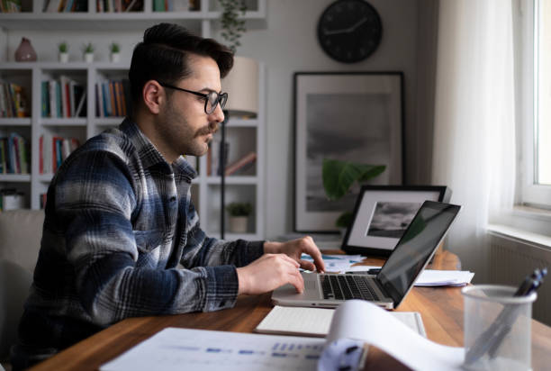 istock Young man working at home in the evening 1300023693