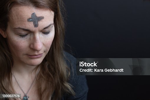 istock Woman with ash cross on forehead 1300027176