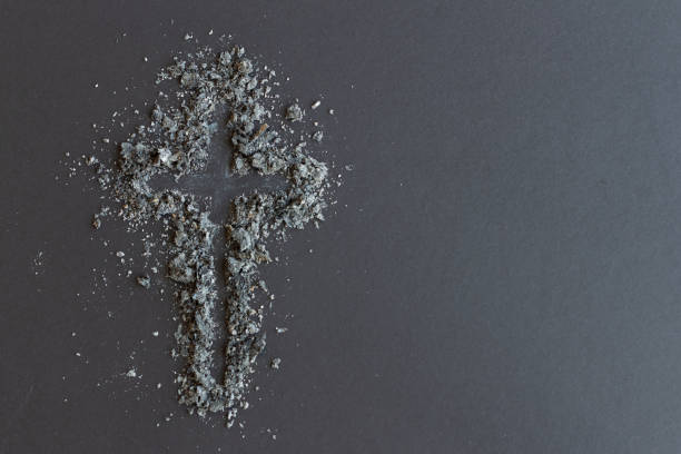 istock Cross of ashes on dark background 1300027177