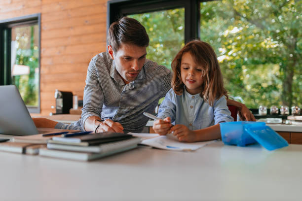 istock Single father helping his son about education at home 1300028493