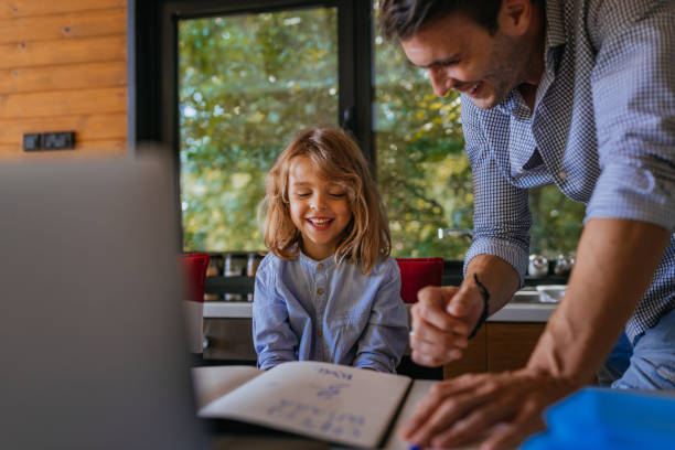 istock Single father helping his son about education at home 1300028540
