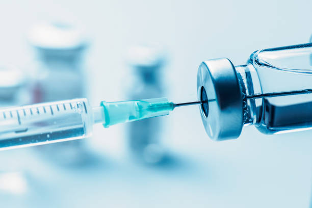 istock Vaccine bottle and syringe closeup 1300028790