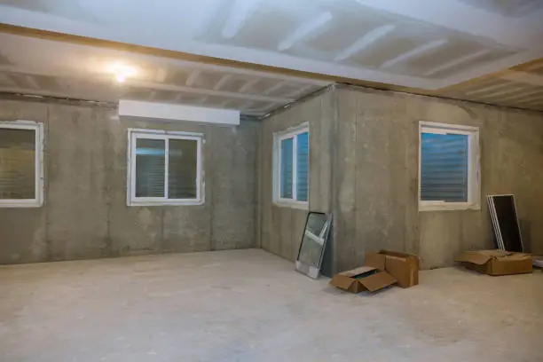 Photo of Unfinished view on concrete floor construction of basement empty under construction of home