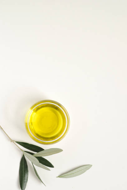istock Natural kitchen or cosmetic mock-up with olive branches and olive oil, white background, minimalism style, copy space 1300034663