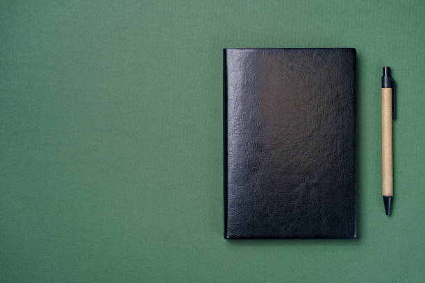 istock Leather notebook cover on a green background 1300035858