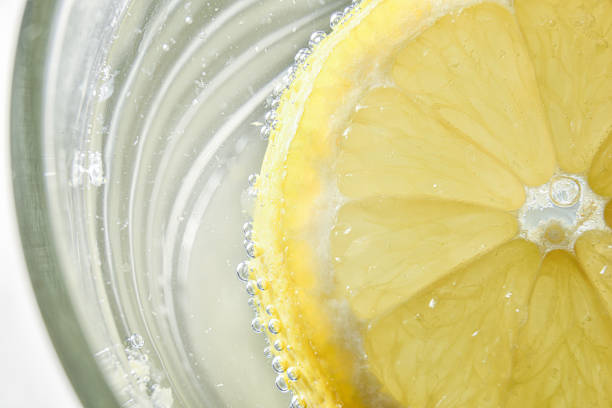 istock Glass with water and lemon slice floating detail 1300036530