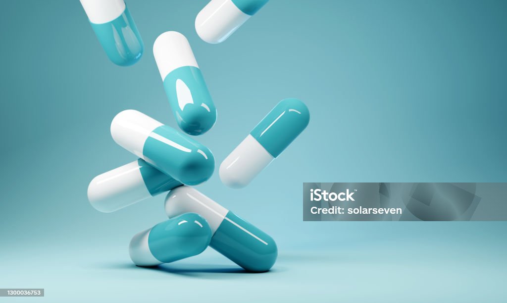 Falling Antibiotics Healthcare Background A group of antibiotic pill capsules fallling. Healthcare and medical 3D illustration background. Medicine Stock Photo