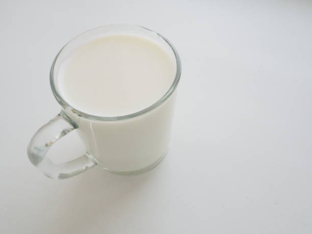 istock Glass cup with milk on a white background. Diet protein food 1300038423