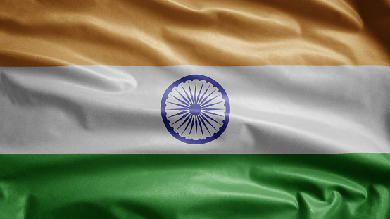 Tiranga indian flag waving in the wind. Close up of India banner blowing, soft and smooth silk. Cloth fabric texture ensign background. Use it for national day and country occasions concept.