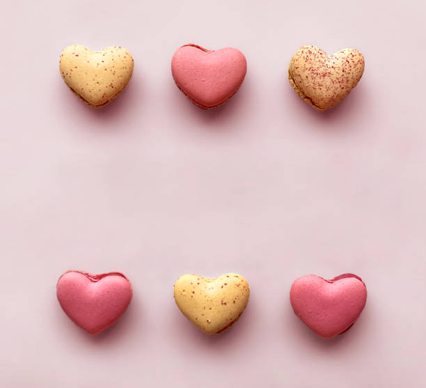 istock Heart Shaped Valentine's Day Macaroons Border Shot from Above on Light Pink Background 1300043303