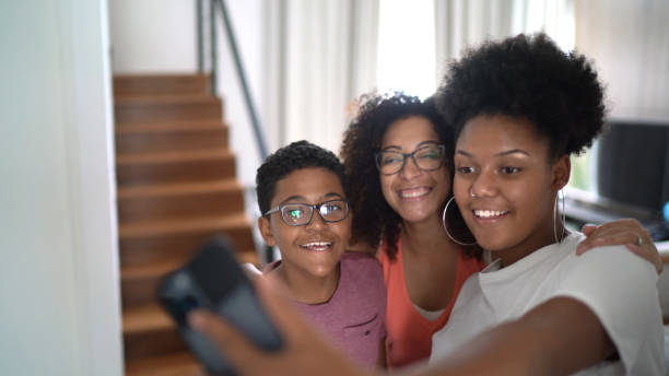 istock Family taking a selfie  / video call at home 1300046775