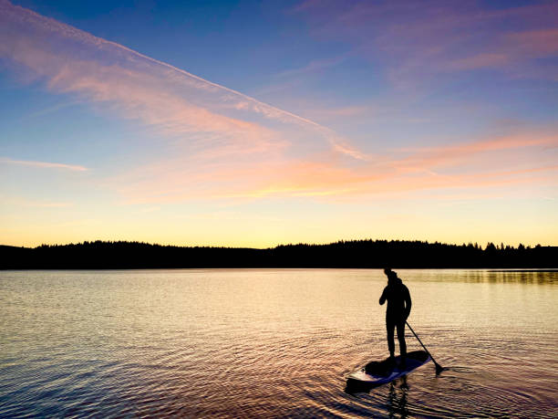 istock Beauty, strength, and balance on a paddle board 1300048598