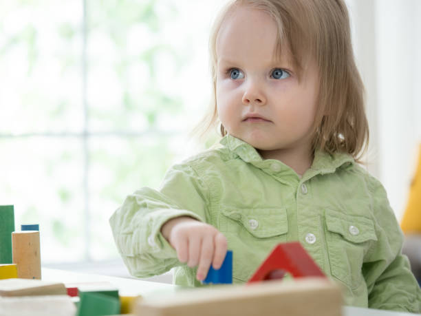 istock Adorable girl playing with blocks 1300049485