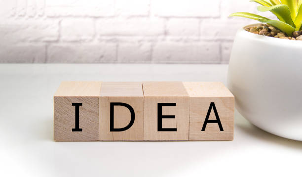 istock Wooden elements cubes with letters and the word IDEA on a light table against a brick wall, the concept of business and innovation 1300049486