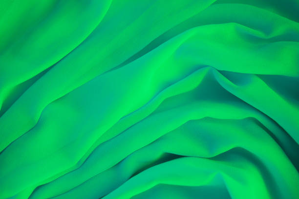 istock Green fabric or luxury silk satin for background. 1300052067