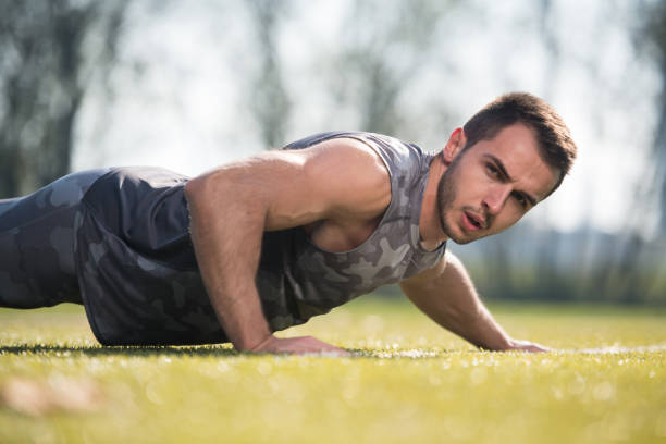 istock Sports Man Doing Pushups in the Park 1300053264