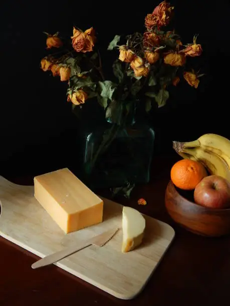 Photo of My appetizer of cheese and fruit in the company of dried roses
