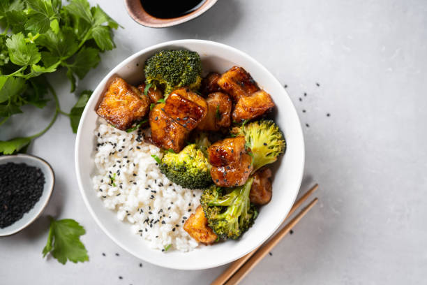 istock Healthy tofu bowl with broccoli and rice on white 1300056356