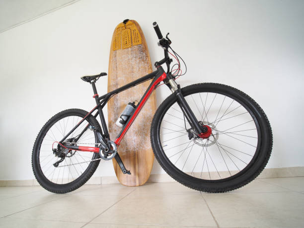 istock Bicycle with a surfboard at home. Sport concept. 1300064657