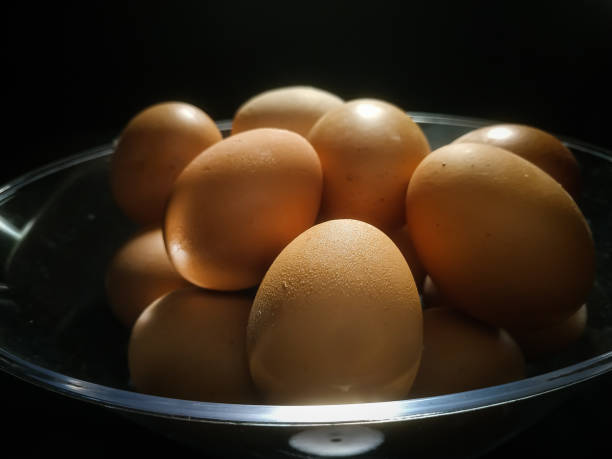 istock a bowl of eggs isolated on black background 1300065387
