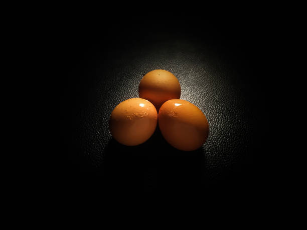 istock a bowl of eggs isolated on black background 1300065403