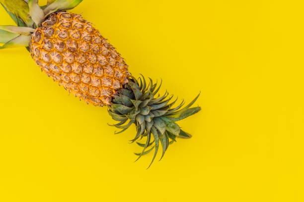 istock Pineapple on yellow background. Summer concept. Flat lay, top view 1300068394