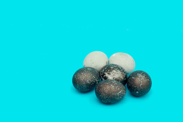 istock A bunch of beautiful unusual easter eggs lies on a blue background 1300076696