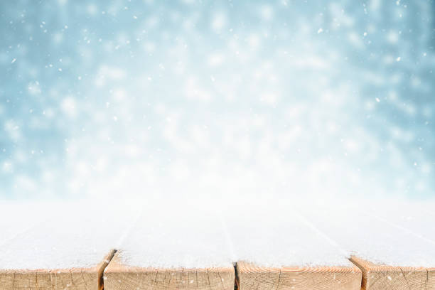istock Empty snow covered wood surface and bokeh blur abstract background 1300076731