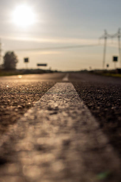 istock A long white stripe, like a road marker. A road between fields 1300077771