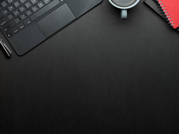 istock Workspace with laptop keyboard, coffee cup, notebooks and copy space in home office room 1300078748
