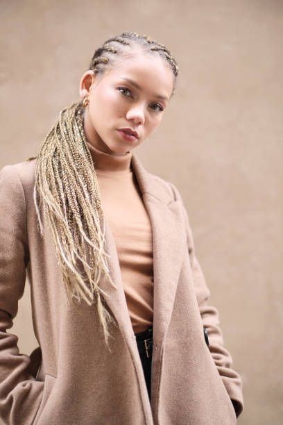 Portrait of a young woman on a beige coat. Youth culture
Made in Barcelona.
Portrait of a young woman on a beige coat. black woman hair extensions stock pictures, royalty-free photos & images