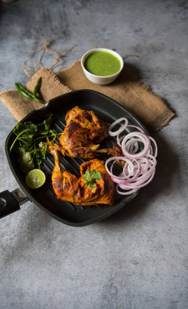 istock Chicken tandoori in a pan 1300079217