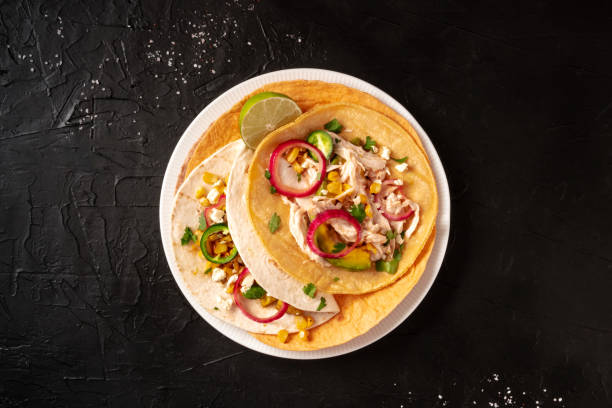 istock Mexican tacos, tortillas with pulled chicken meat 1300079976