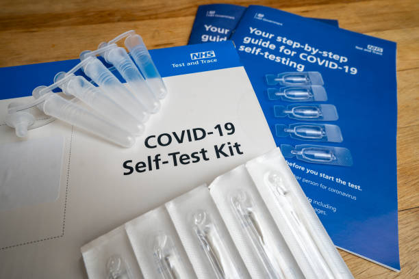Covid-19 Coronavirus pandemic new variant full home test self diagnosing kit issued by NHS national health service for testing with swabs and instructions for self isolation Issued to members of the UK public in February 2021 for emergency service key workers and teachers to test themselves for Covid 19 virus. Includes guidance instructions, swabs, test viles and liquid. medical test stock pictures, royalty-free photos & images
