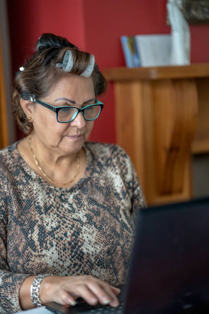 istock Mature Hispanic woman wearing hair rollers 1300081184