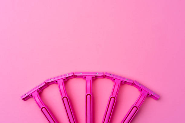 istock Female disposable razors on pink background top view 1300081242
