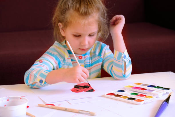 istock little girl draws funny hearts 1300082107