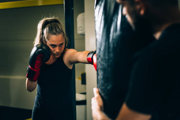 woman athlete training boxing young woman has boxing training sleeveless top stock pictures, royalty-free photos & images