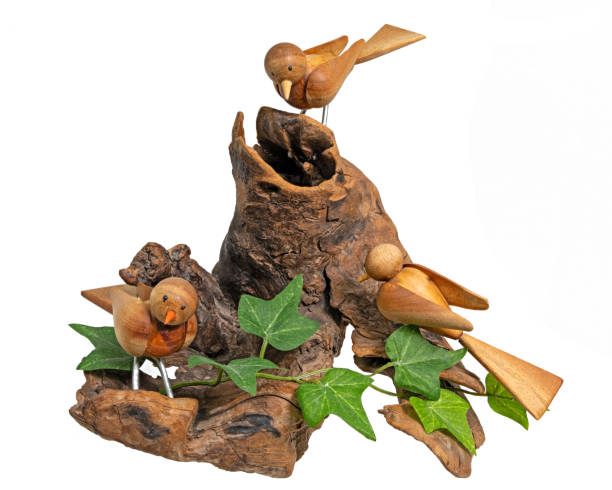 istock Wooden model with 3 turned birds on a tree root 1300084045
