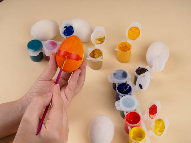 istock hand painting modern easter egg top view. preparation for holiday, easter celebration. stylish painted egg. 1300084871