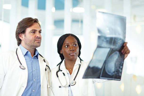 istock Two doctors examining an X-ray image in hospital. 1300085368