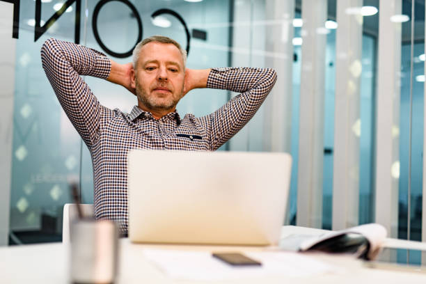 istock Relaxed male entrepreneur reading an e-mail on a computer in the office. 1300085502