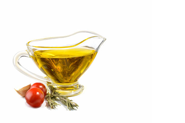 istock Natural vegetable oil in a small glass cup, isolated on a white background. 1300086178