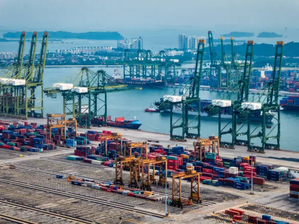 Singapore, Singapore - August 05, 2018: Amazing view of a container terminal at the Port of Singapore. Ship-to-shore gantry cranes at shipping yard