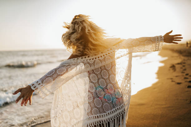 istock Happy woman on the beach 1300087459